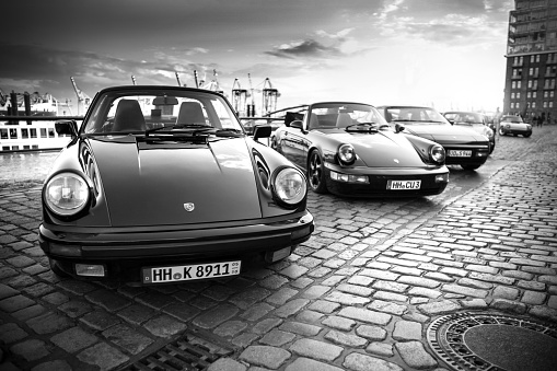 A row of parked Porsche 911 vehicles during the event with Magnus Walker on the Fish Market Hamburg