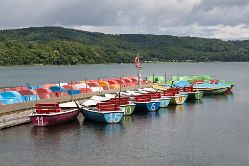 Colorful rowboats and pedalos for rental in a German lake