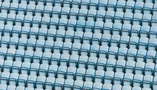Rows of blue plastic stadium seats. stock photo