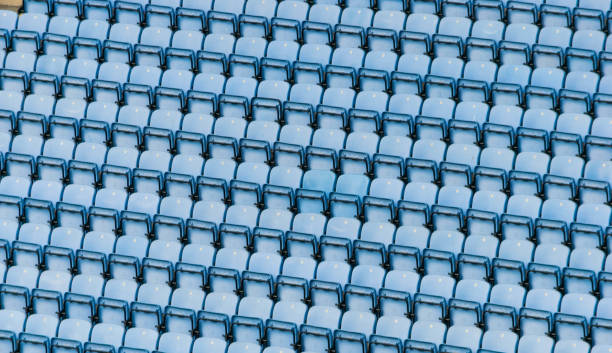 Rows of blue plastic stadium seats. stock photo