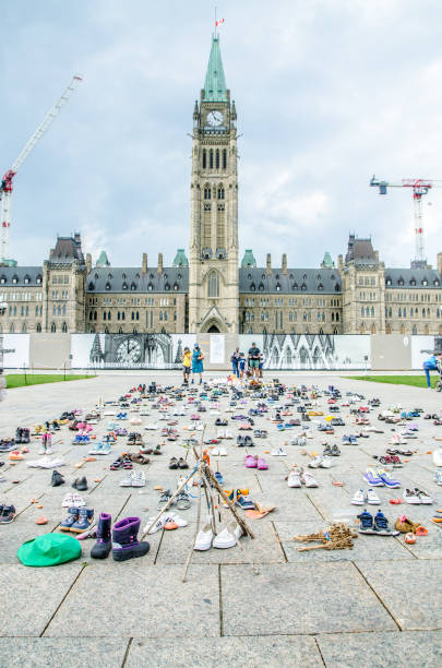 Rows of child's boots and shoes in front of Ottawa Parliament stock photo