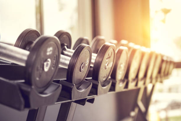 Rows of dumbbells in the gym with sunlight. Rows of dumbbells in the gym with sunlight in morning. weight stock pictures, royalty-free photos & images