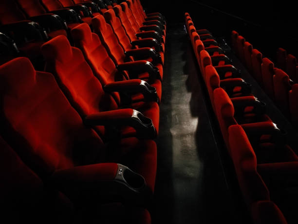 Rows of empty red seats at the movie theater stock photo