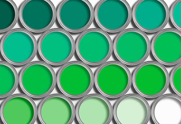 Rows of open green paint in paint tins on white stock photo