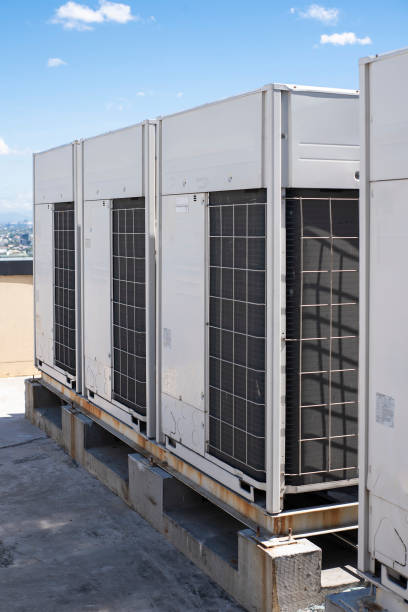 Rows of rooftop HVACs on the roof deck of an office tower. VRF air conditioner for commercial buildings stock photo
