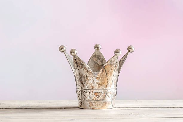 Royal crown on pink background stock photo