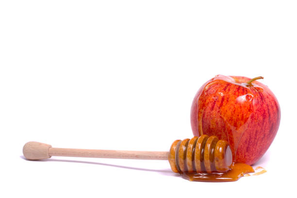 royal gala apple with a honey dipper stock photo