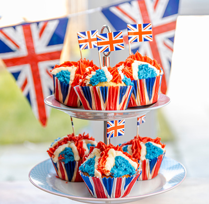 Red White and Blue, British Royal Jubilee Cupcakes, to celebrate the Queen's Platinum Jubilee. Designed in the shape of the Union Jack Flag, to represent Great Britain's monarchy in preparation for the Platinum Lunch and street parties that will be happening around the Uk in June.