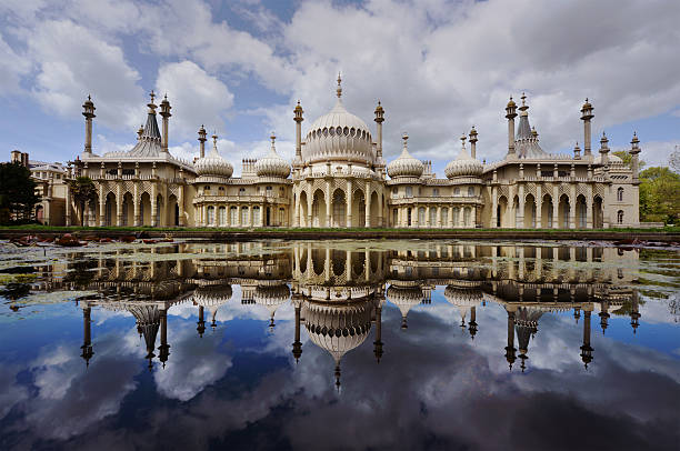 Royal Pavilion reflection "The Brighton Pavilion reflected in an ornamental pondStraight wide-angle photograph - no image manipulationThe Royal Pavilion is a former royal residence (now a public building) located in Brighton, England. It was built in three stages, beginning in 1787, as a seaside retreat for George, Prince of Wales, from 1811 Prince Regent. It is often referred to as the Brighton Pavilion. with copy space" brighton stock pictures, royalty-free photos & images