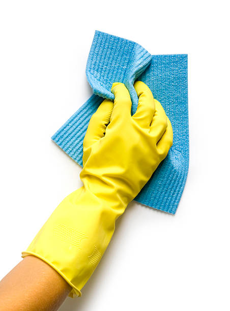 Rubber gloved hand cleaning with a blue cloth stock photo