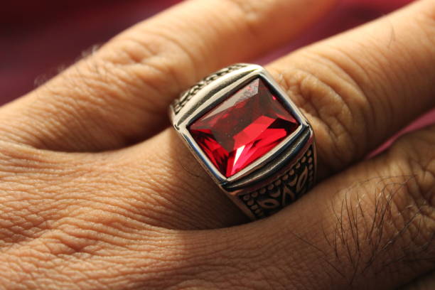 Ruby ring in male finger Ruby ring gold ring on finger stock pictures, royalty-free photos & images