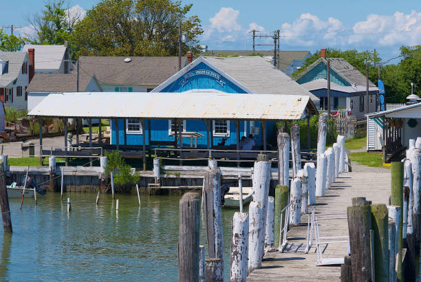 "Rudy Thomas Dock", Tangier Island, Virginia Tangier Island, Virginia / USA - June 21, 2020: The blue-painted “Rudy Thomas Dock” building greets visitors to this popular tourist destination in the Chesapeake Bay. tangier island stock pictures, royalty-free photos & images