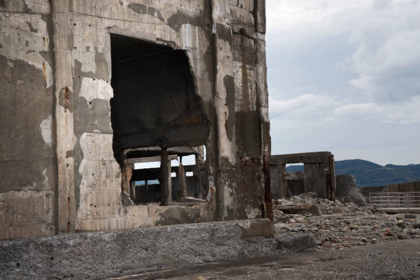 Ruins in Hashima Island, Japan Hashima Island, Japan - 11 April 2019: Hashima Island-Gunkanjima meaning Battleship Island, is an abandoned island lying about 15 kilometers (9 miles) from the city of Nagasaki, in southern Japan. This is former coal mining island. It is old coal mine in Japan closed at 1974 due to the closure of coal mine. sites of japan's meiji industrial revolution stock pictures, royalty-free photos & images