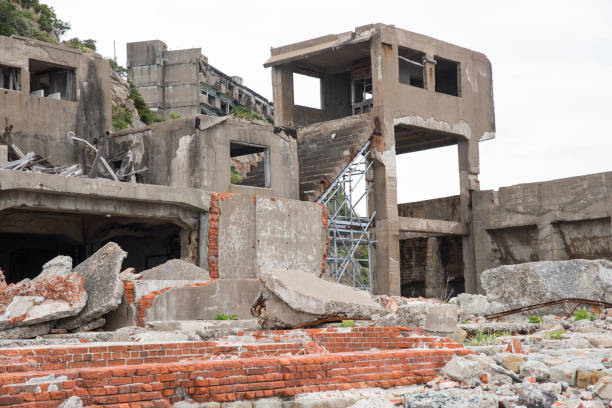 Ruins in Hashima Island, Japan Hashima Island, Japan - 11 April 2019: Hashima Island-Gunkanjima meaning Battleship Island, is an abandoned island lying about 15 kilometers (9 miles) from the city of Nagasaki, in southern Japan. This is former coal mining island. It is old coal mine in Japan closed at 1974 due to the closure of coal mine. mitsukejima island stock pictures, royalty-free photos & images