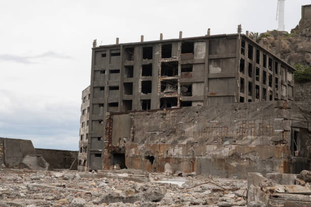 Ruins in Hashima Island, Japan Hashima Island, Japan - 11 April 2019: Hashima Island-Gunkanjima meaning Battleship Island, is an abandoned island lying about 15 kilometers (9 miles) from the city of Nagasaki, in southern Japan. This is former coal mining island. It is old coal mine in Japan closed at 1974 due to the closure of coal mine. mitsukejima island stock pictures, royalty-free photos & images
