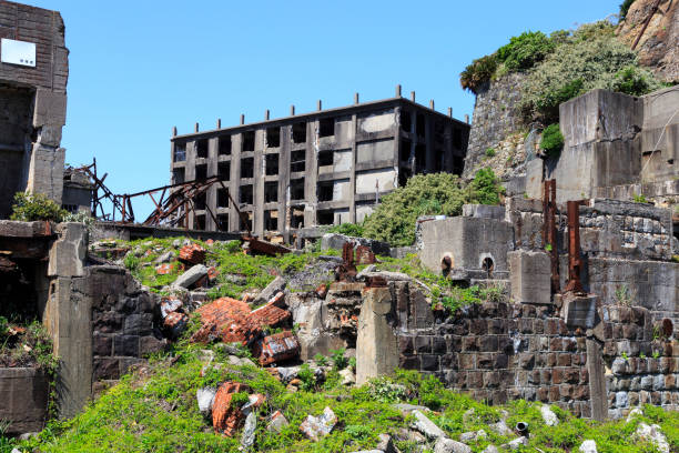 Ruins in Hashima Island, Japan Ruins in Hashima Island, Japan sites of japan's meiji industrial revolution stock pictures, royalty-free photos & images
