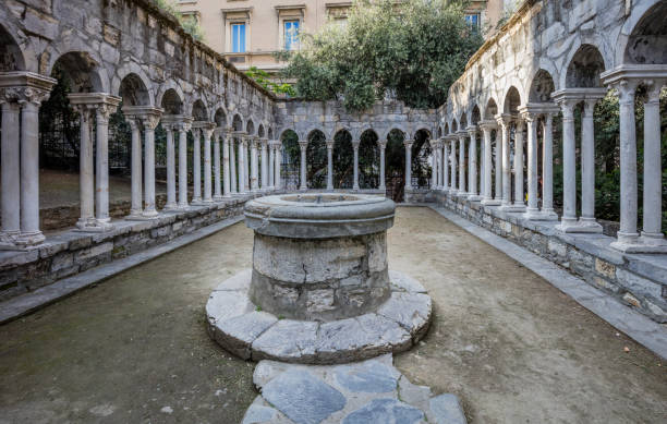 Ruins of St Andrew cloister with water well in old center of Genoa, Italy stock photo