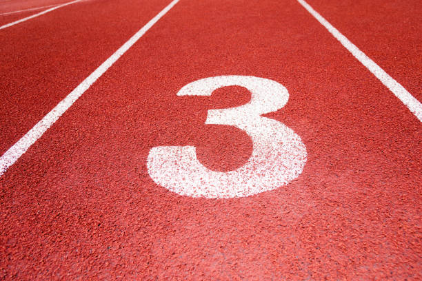 Running track number 3 in sport field Running track number 3 in sport field asien startblock stock pictures, royalty-free photos & images