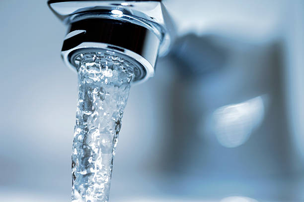 Running Water Faucet Faucet close-up with running water. faucet stock pictures, royalty-free photos & images