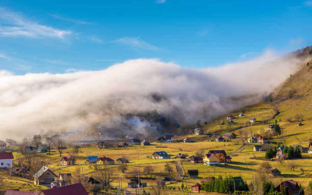 Rural landscape with fog Rural landscape with fog in Sirnea, Fundata village, Transylvania landmark, Romania bucegi mountains stock pictures, royalty-free photos & images