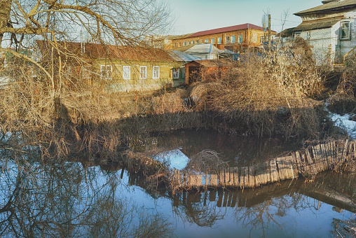 Russia, Balashov April 13, 2018. Sunken under water fence garden. Flooded during the spring flood of the Hoper River suburban houses. High water in the river stream Cityscape town embankment