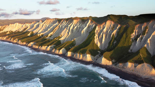Russia, Kuril Islands, Iturup Island, White rocks on coast of the Sea of Okhotsk. Aerial view. stock photo