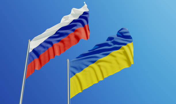 Russian and Ukrainian Flags Waving With Wind Russian and Ukrainian flags are waving with wind over  blue sky. Low angle view. Dispute and conflict concept. Horizontal composition with copy space. russia stock pictures, royalty-free photos & images