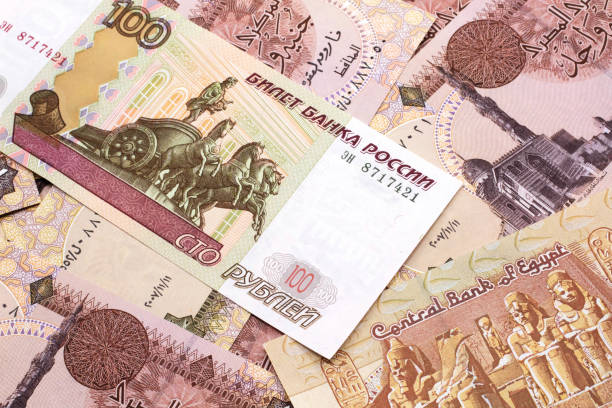A Russian ruble bank note on a background of Egyptian pound stock photo