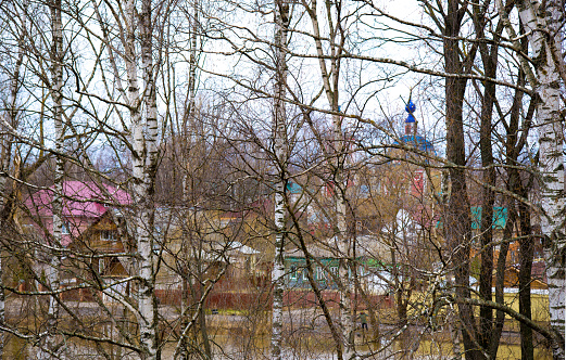 Meandering river Seversky Donets in the middle of green hills overgrown with forest and Svyatogorskaya Svyato-Uspenskaya Lavra along-shore, view from above