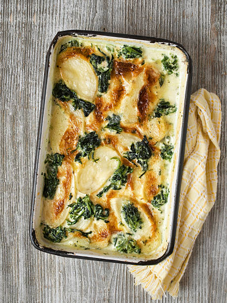 rustic golden spinach potato gratin dauphinois close up of rustic golden spinach potato gratin dauphinois gratin stock pictures, royalty-free photos & images