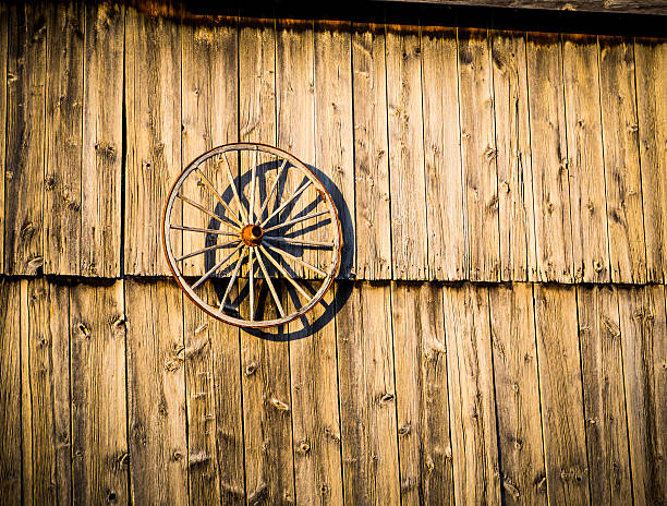 Rustic Old Barn and Wagon Wheel stock photo