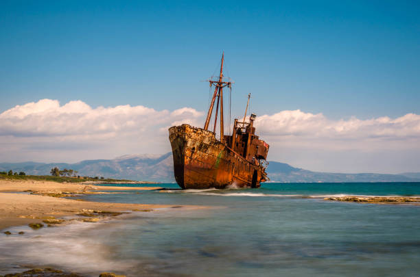 Rusty and abandoned shipwreck stands on a coastline near Gythio in Lakonia. stock photo
