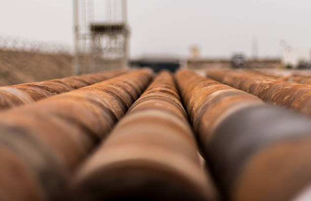 rusty drilling oil rig pipes stock photo