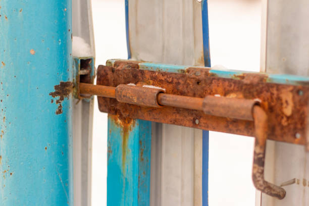 A rusty old bolt on the metal doors A rusty old bolt on the metal doors rusty fence stock pictures, royalty-free photos & images