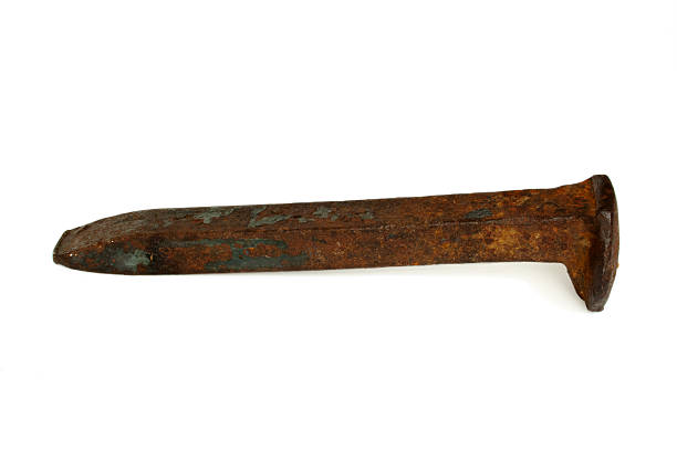 Rusty Railroad Spike An old, rusty railroad spike isolated on white. spiked stock pictures, royalty-free photos & images