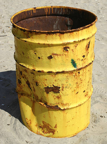 rusty trash can on the beach stock photo
