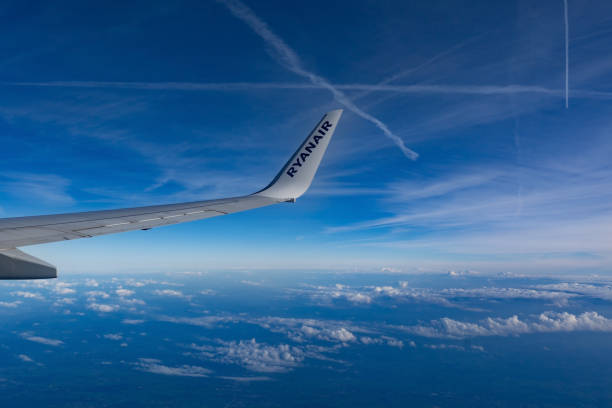 A Ryanair plane wing with winglet above the clouds stock photo