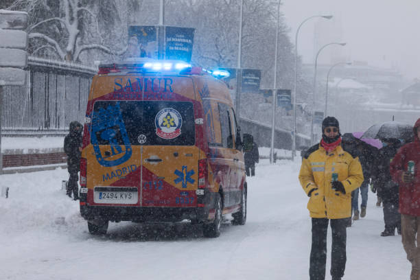 SAMUR's ambulance vehicle in emergency, Madrid. Madrid, Spain - January 09, 2021: SAMUR's ambulance vehicle, public health services, in emergency, on a snowy day, due to the Filomena polar cold front. public service stock pictures, royalty-free photos & images