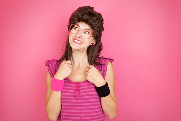 80's Mullet Geek A smiling 80's styled woman with a mullet and big glasses. mullet haircut stock pictures, royalty-free photos & images