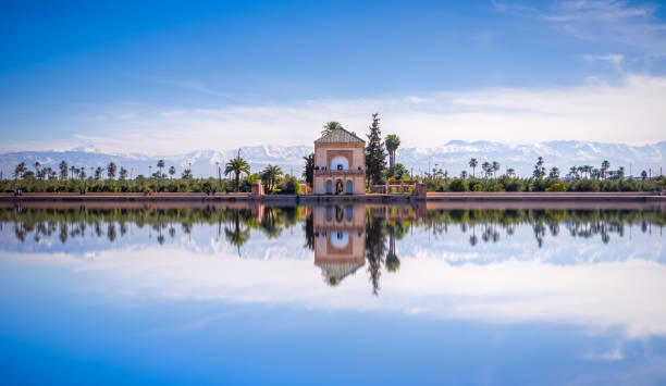 Saadian pavilion, Menara gardens and Atlas in Marrakech, Morocco, Africa Panoramic view of Saadian pavilion, Menara gardens and Atlas mountains in Marrakech, Morocco, Africa morocco stock pictures, royalty-free photos & images