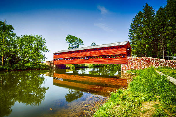 Sachs Covered Red Bridge at Marsh Creek in Pennsylvania Sachs Covered Red Bridge at Marsh Creek in Pennsylvania covered bridge stock pictures, royalty-free photos & images