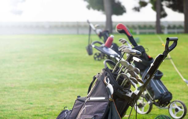 Sack of golf clubs on an empty field. golf training stock photo