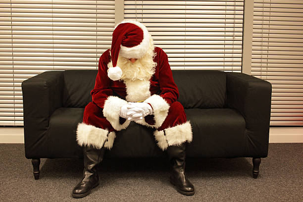 Sad and depressed Santa Claus waiting for christmas stock photo