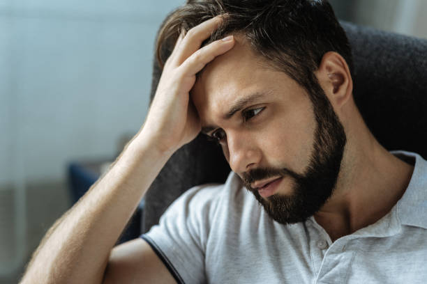 Sad bearded man feeling frustrated stock photo
