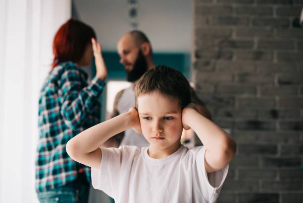 Sad child covering his ears with hands during parents quarrel. Sad child covering his ears with hands during parents quarrel. Man about to beat his wife domestic violence stock pictures, royalty-free photos & images