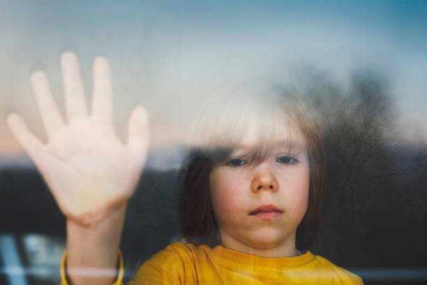 Sad child in isolation at home stock photo