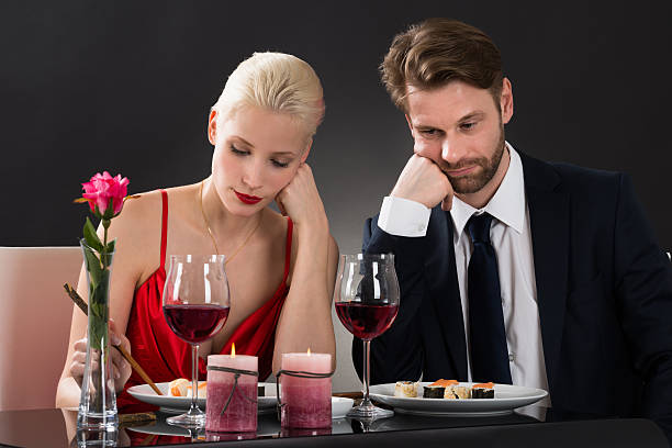 sad couple having dinner at a restaurant - boring date bildbanksfoton och bilder