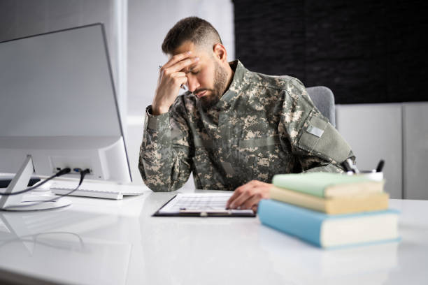 Sad Frustrated Military Veteran Student Doing Test Sad Frustrated Military Veteran Student Doing Test In College military colleges stock pictures, royalty-free photos & images