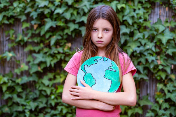 Sad girl is worried about our planet stock photo