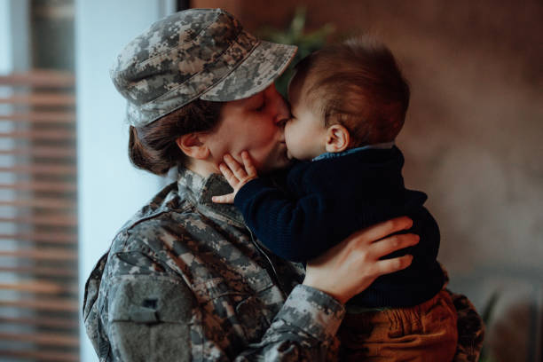 Sad military soldier says goodbye to her son  soldiers returning home stock pictures, royalty-free photos & images